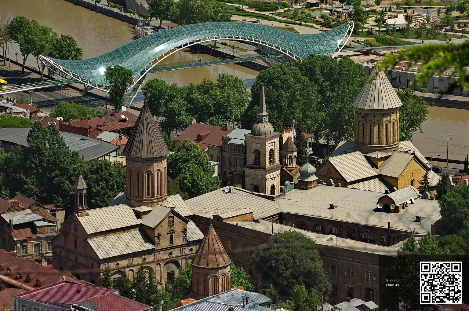 Tbilisi's Old Town skyline with the Bridge of Peace over the Kura River, a landmark Syrian visitors will recognise.