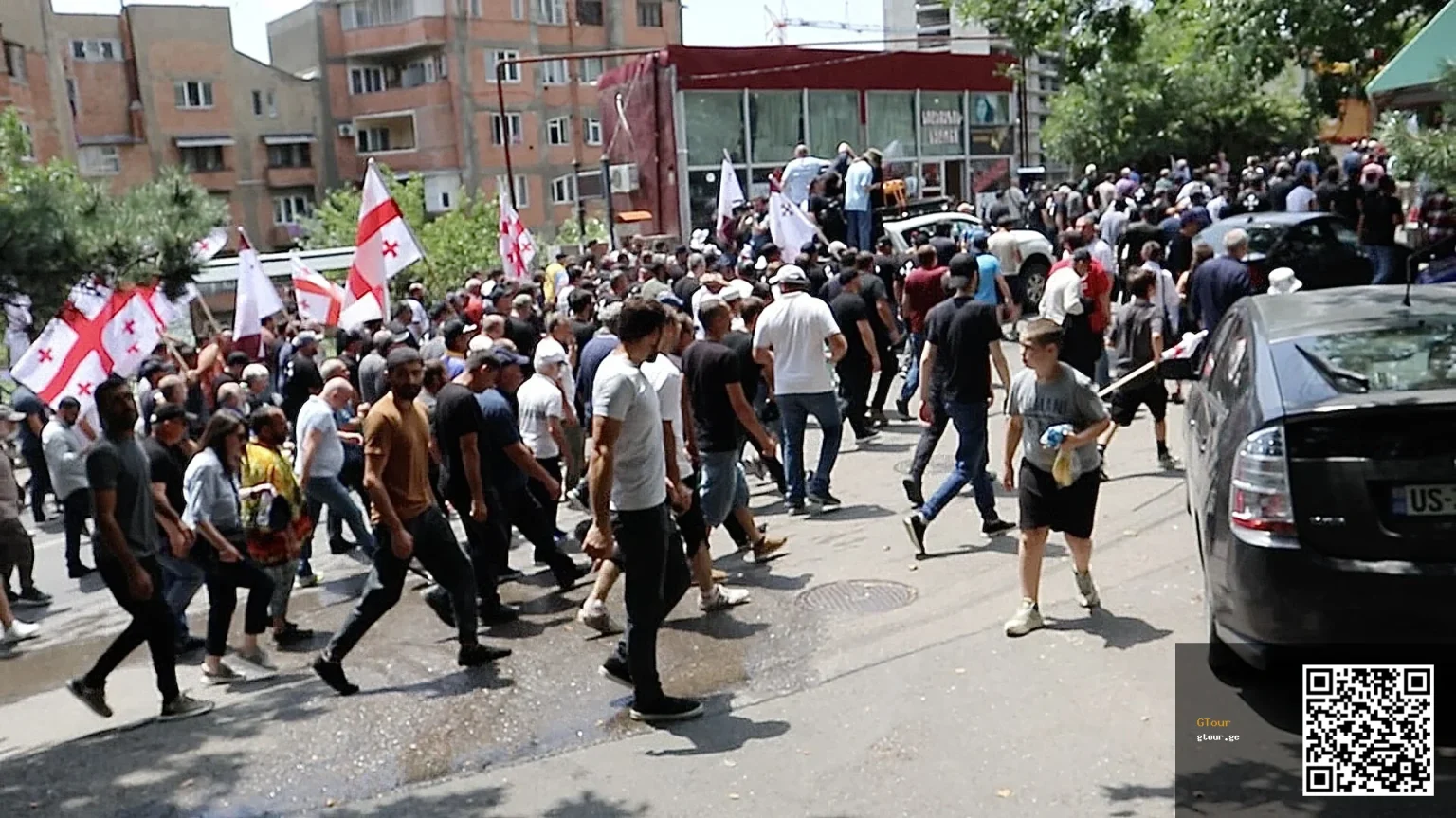 Anti-LGBT nationalist protesters march through a Tbilisi neighborhood during the 2023 Pride attack.
