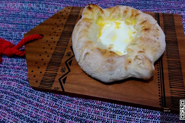Adjaruli khachapuri, Georgia's iconic cheese-and-egg bread that Greek visitors should try.