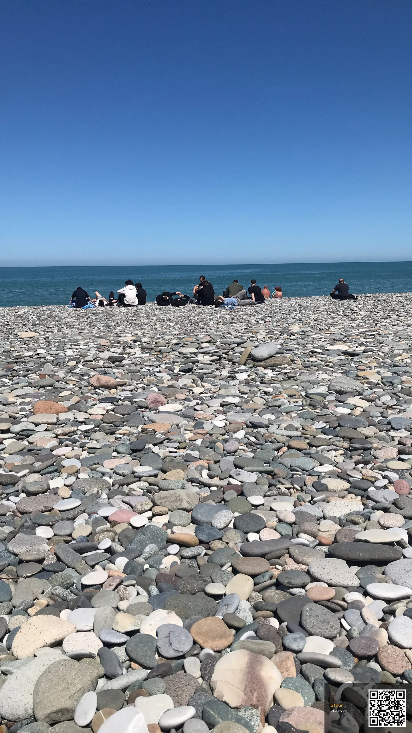 Visitors relax on Batumi's pebble beach along the Black Sea coast.
