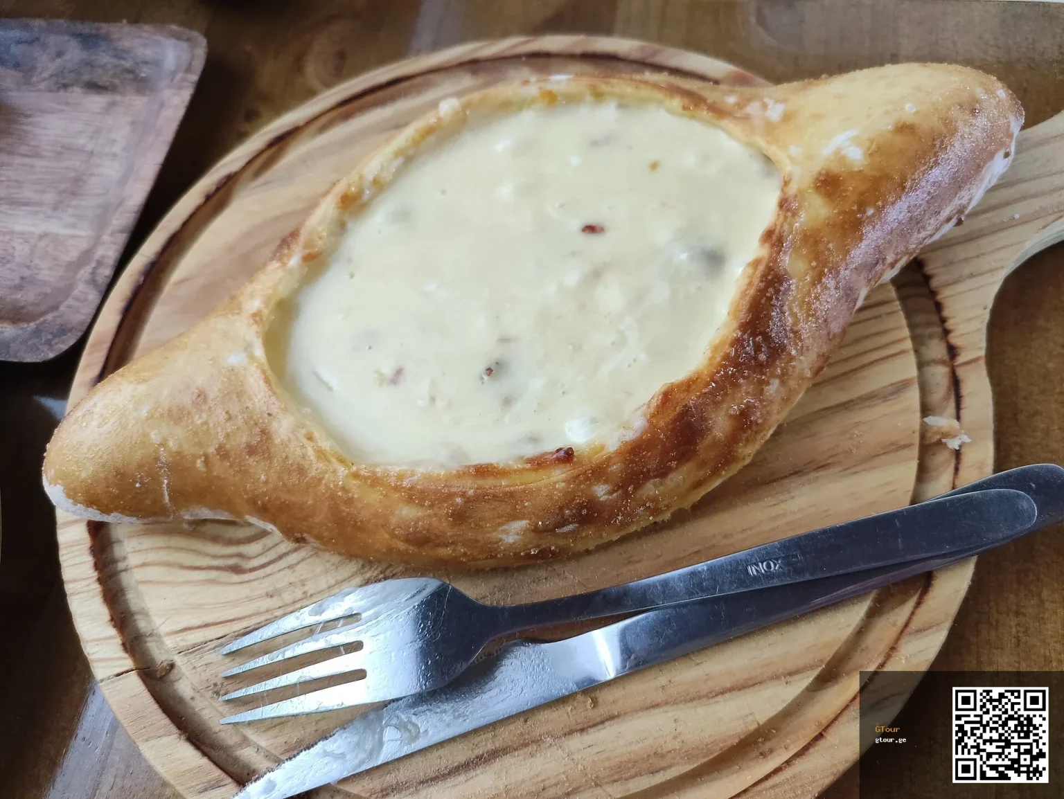 Khachapuri, Georgia's iconic cheese-filled bread, a must-try dish for Moldovan visitors.