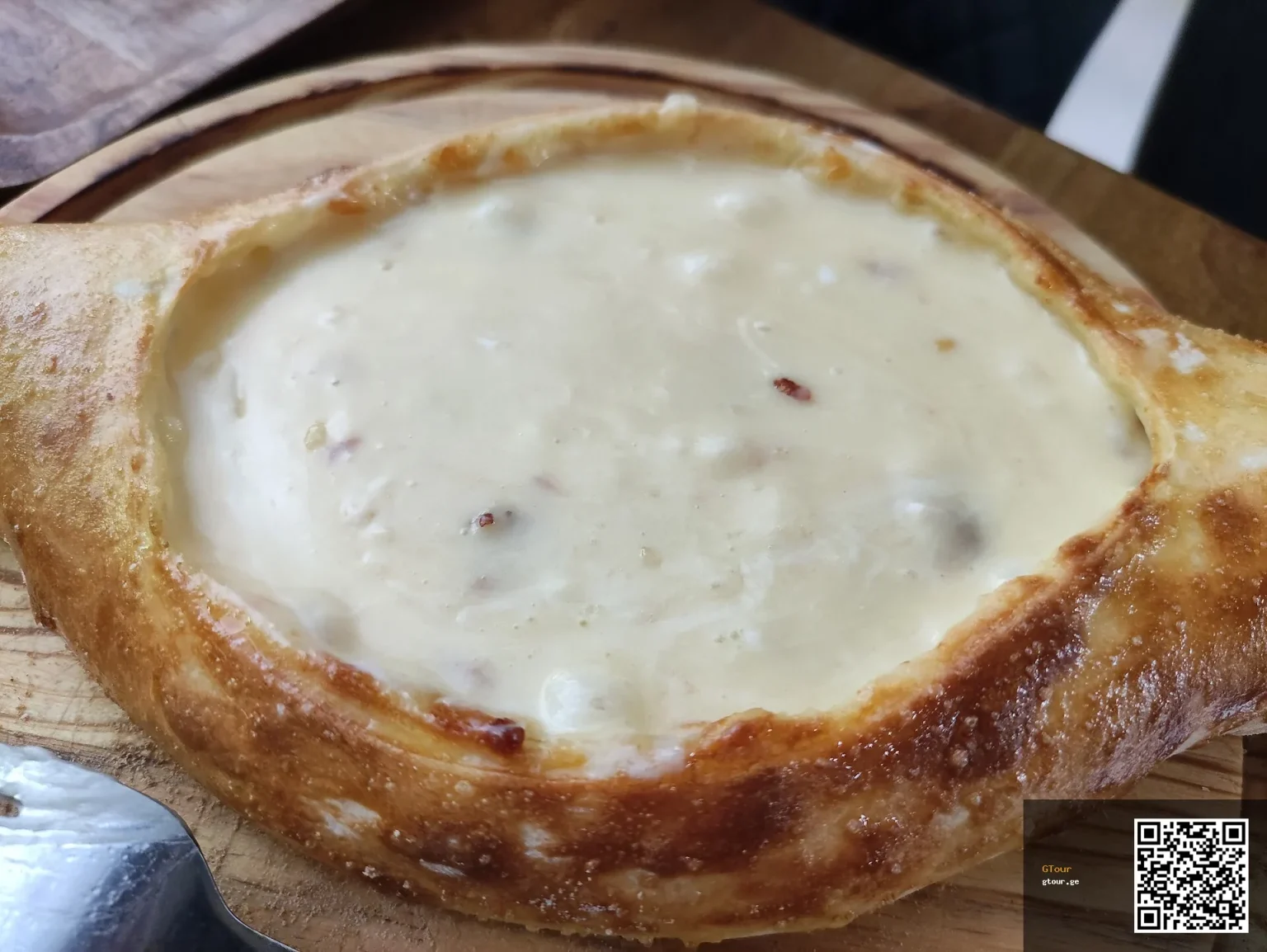 Khachapuri, Georgia's iconic cheese-filled bread, a dish Salvadoran visitors should try.