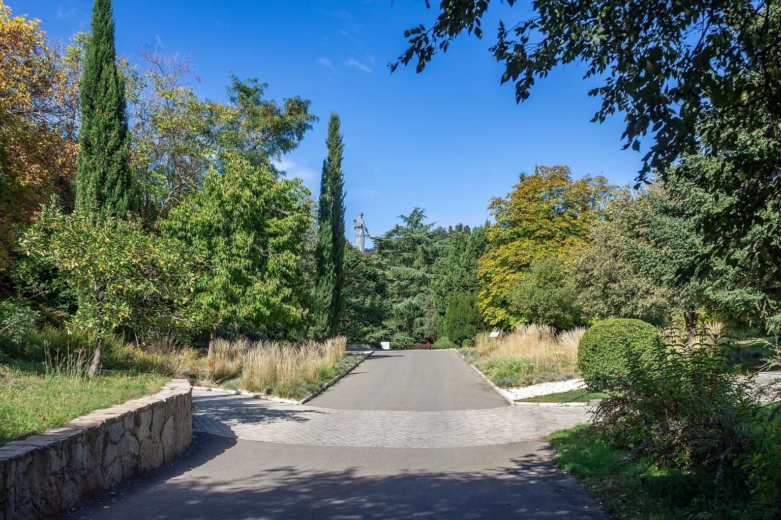 Tree-lined path through Tbilisi's National Botanical Garden, a popular city escape for visitors.