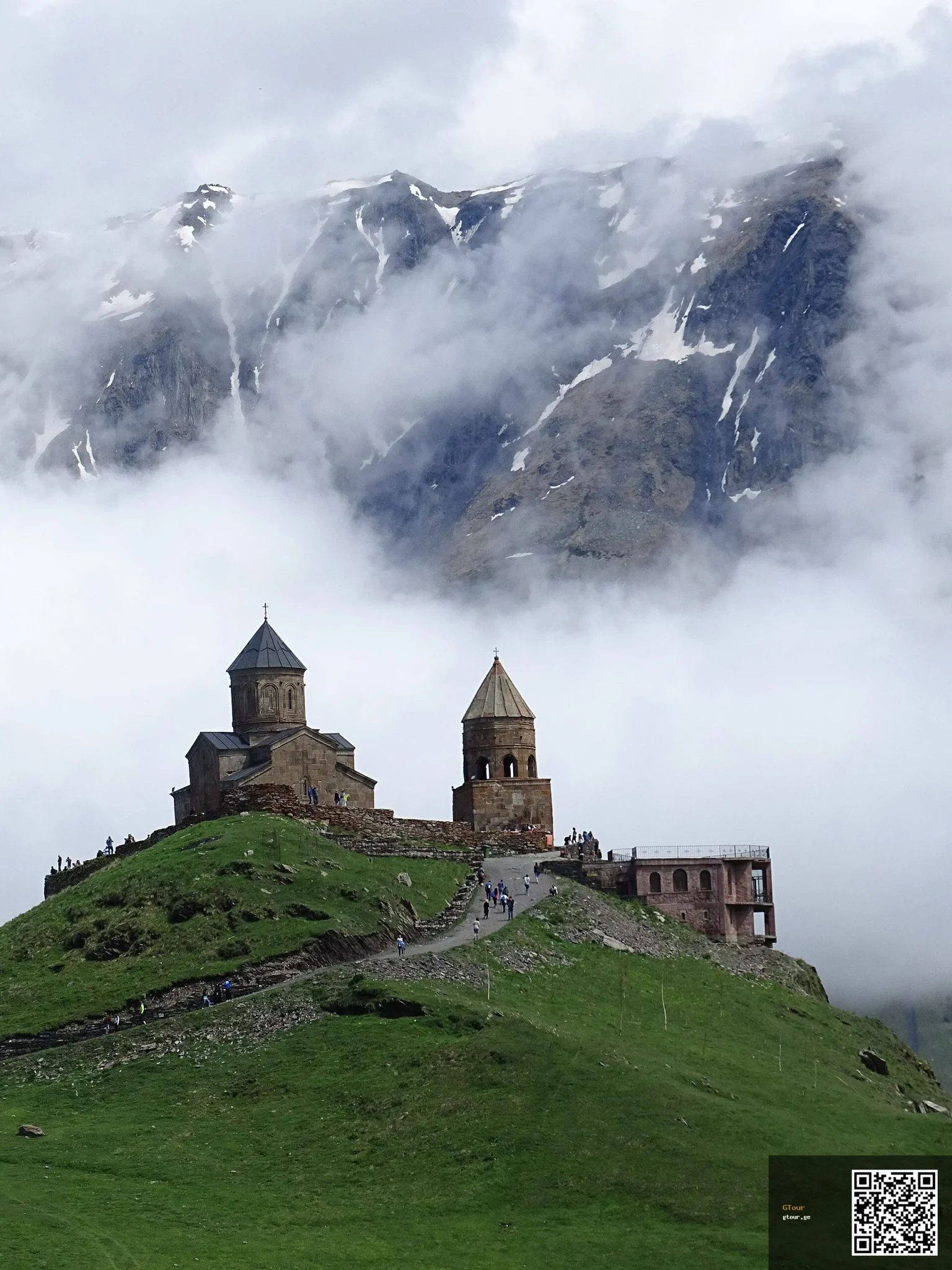 Gergeti Trinity Church perched on a hilltop below Mount Kazbek, Georgia's iconic mountain landmark.