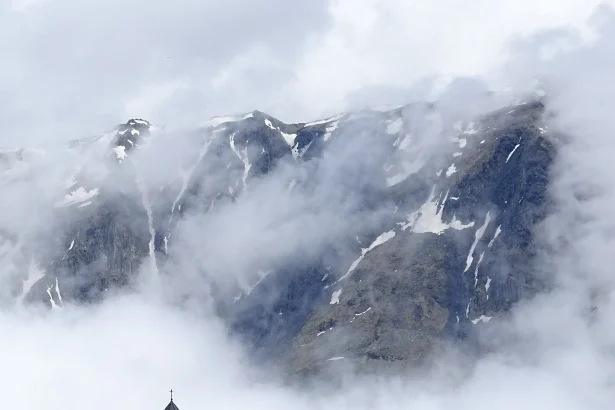Gergeti Trinity Church perched on a hilltop below Mount Kazbek, Georgia's iconic mountain landmark.