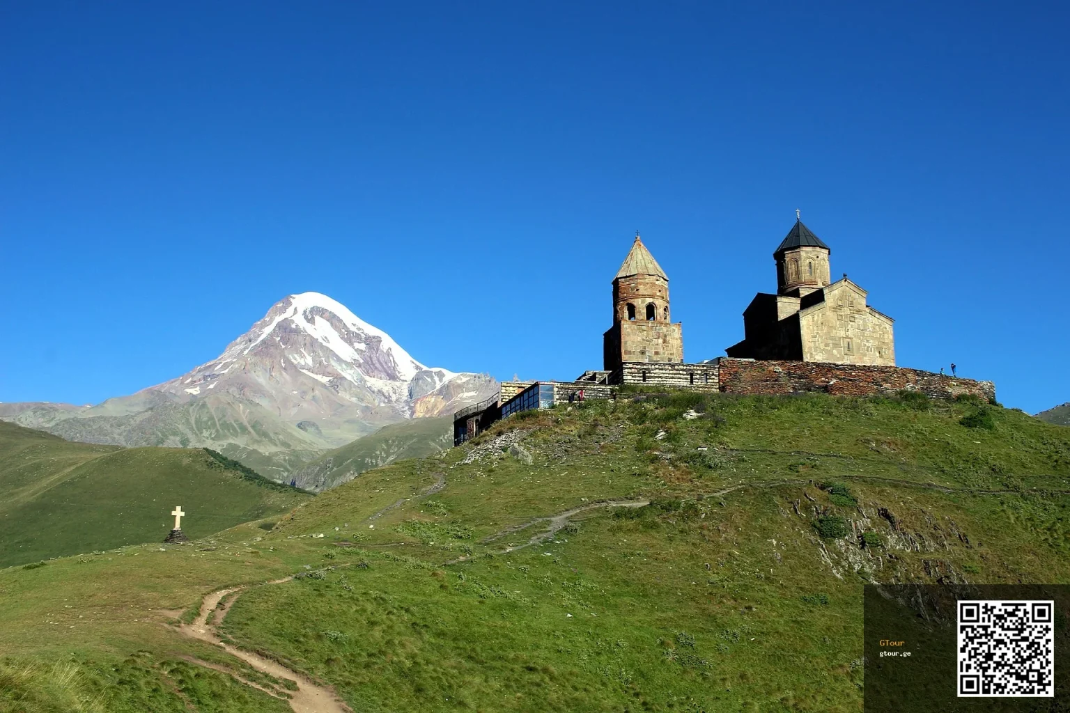 Gergeti Trinity Church beneath snow-capped Mount Kazbegi, a classic Georgian highland landmark.