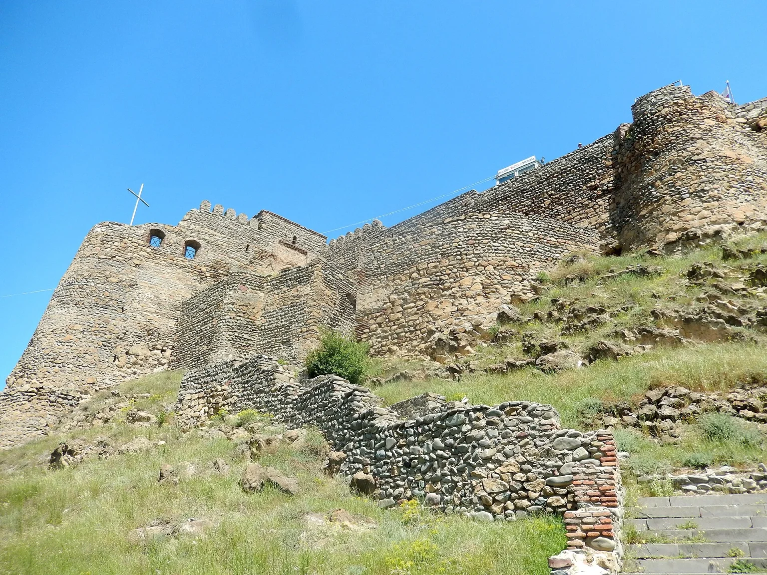 A historic Georgian fortress overlooking a Caucasus town, echoing the country's deep heritage.