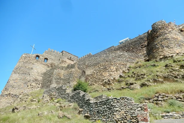 A historic Georgian fortress overlooking a Caucasus town, echoing the country's deep heritage.