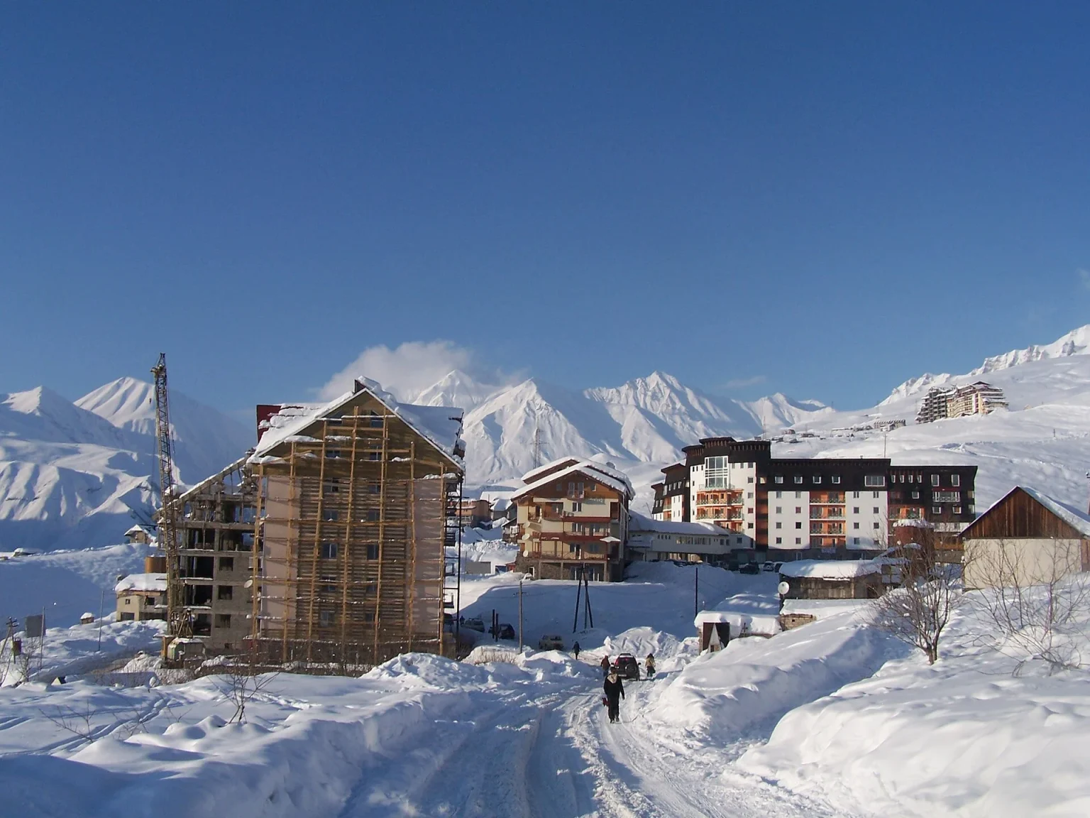 Snow-covered Gudauri village with mountain backdrop, typical of the ski resort in winter.