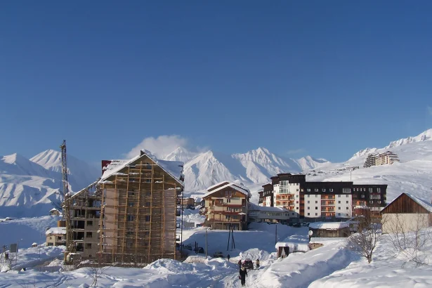 Snow-covered Gudauri village with mountain backdrop, typical of the ski resort in winter.