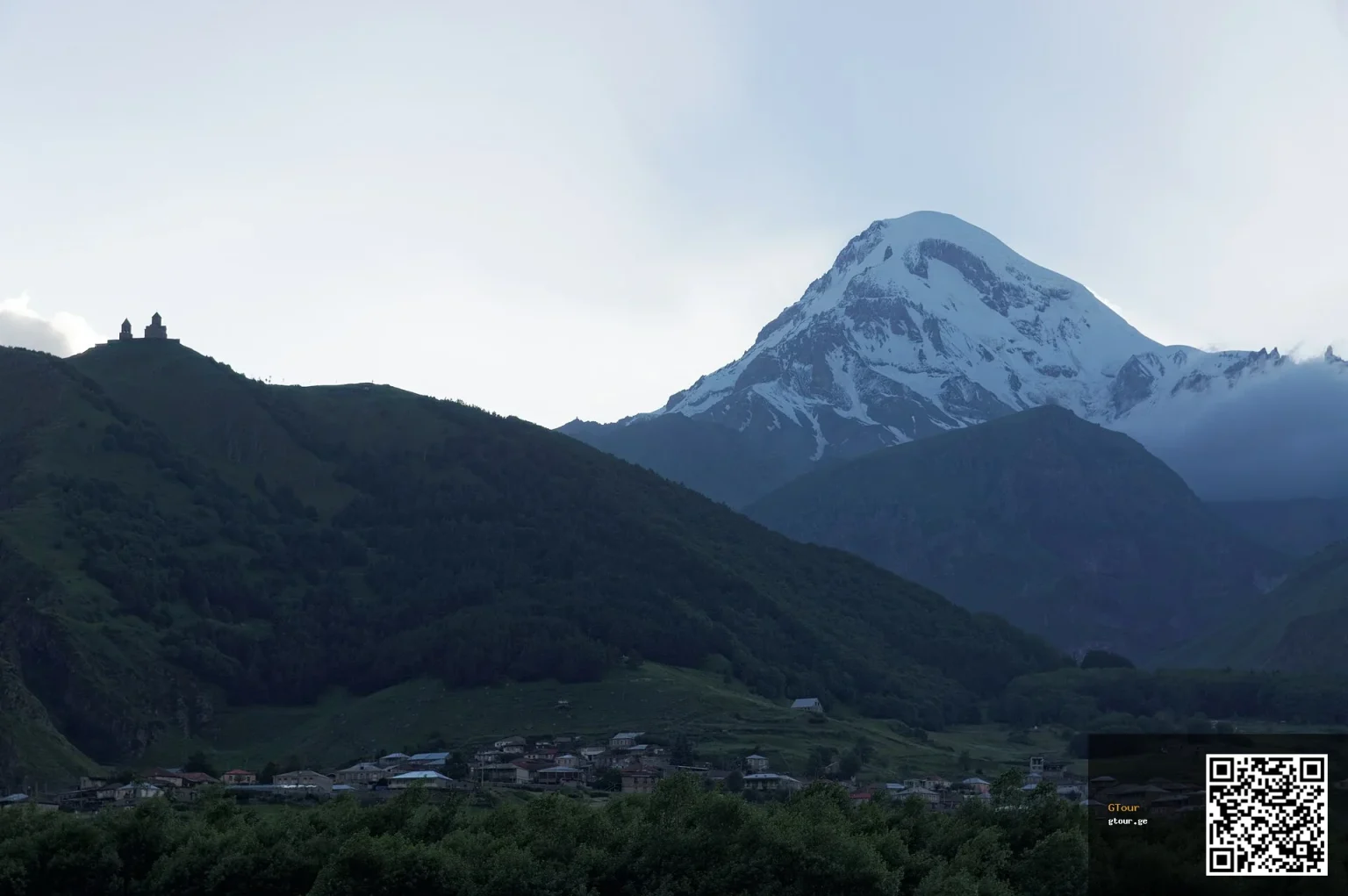 Gergeti Trinity Church beneath snow-capped Mount Kazbek, the iconic sight near Stepantsminda.
