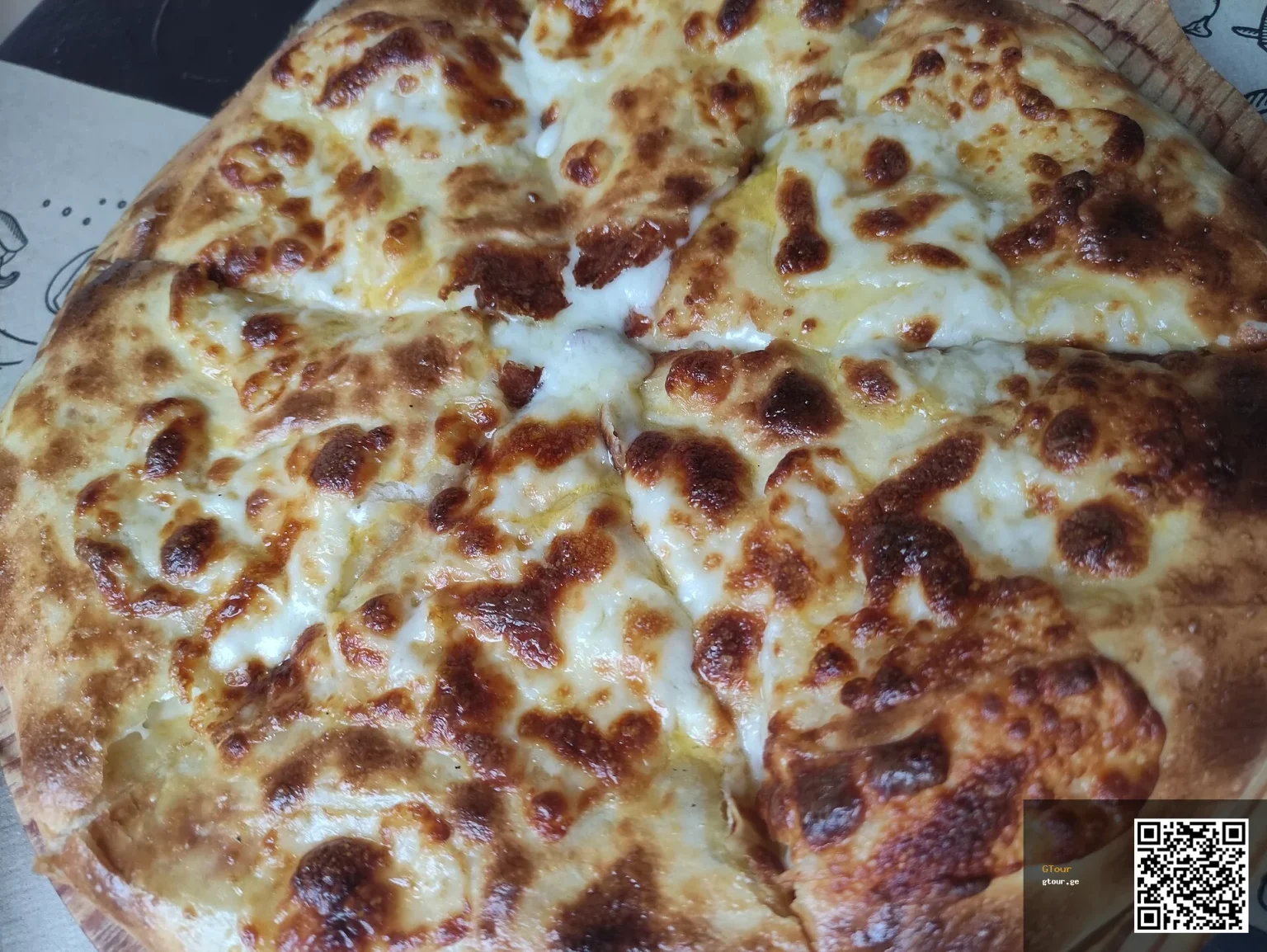 Khachapuri, Georgia's iconic cheese-filled bread, a dish Trinidadian visitors should try.