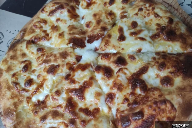 Khachapuri, Georgia's iconic cheese-filled bread, a dish Trinidadian visitors should try.
