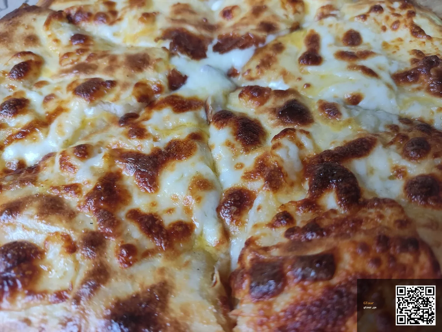 Khachapuri, Georgia's iconic cheese-filled bread, a must-try dish for visitors from Mali.