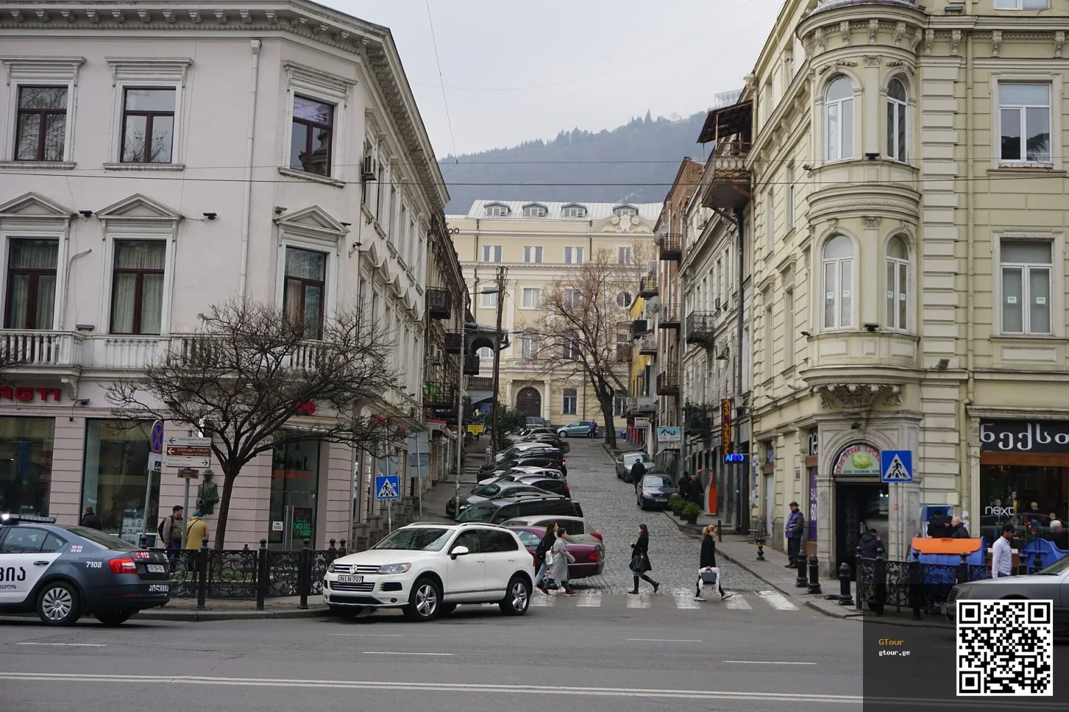 A typical Tbilisi street scene with pedestrians, cars and historic buildings near Mitropane Lagidze Street.
