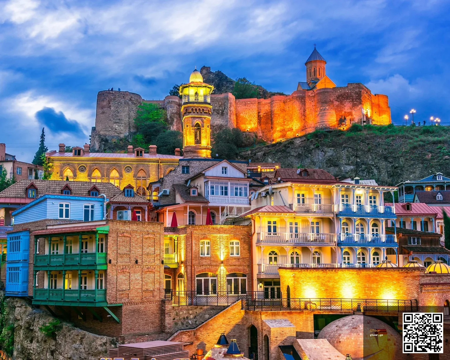 Narikala Fortress glowing above Tbilisi's Old Town, the city most Danish visitors explore first.