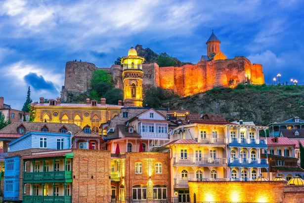 Narikala Fortress glowing above Tbilisi's Old Town, the city most Danish visitors explore first.