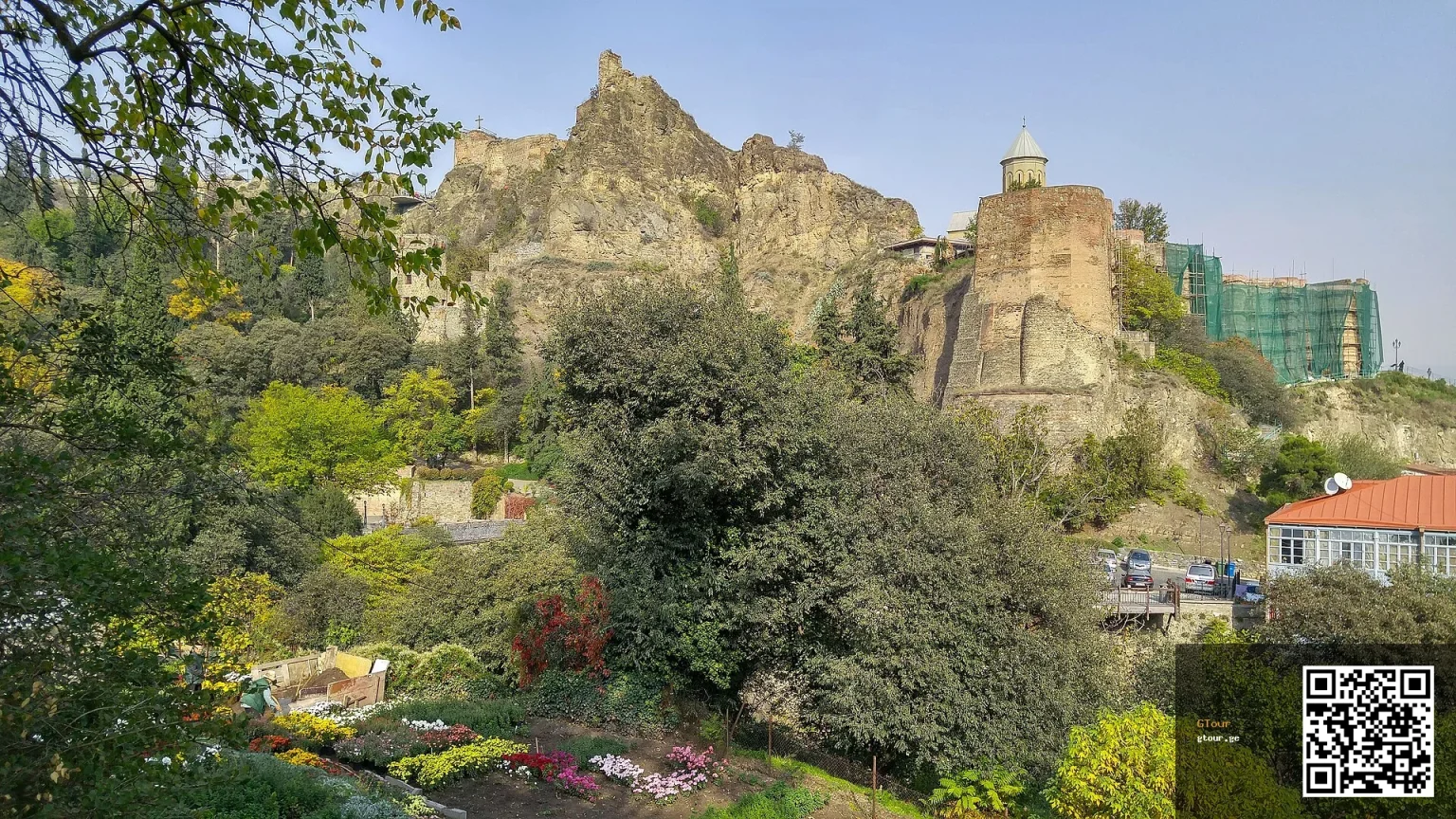 Narikala Fortress ruins rise above Tbilisi's National Botanical Garden, a popular sightseeing stop for visitors.