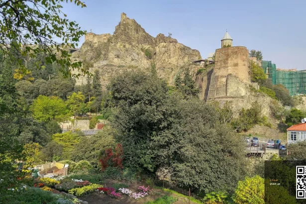 Narikala Fortress ruins rise above Tbilisi's National Botanical Garden, a popular sightseeing stop for visitors.