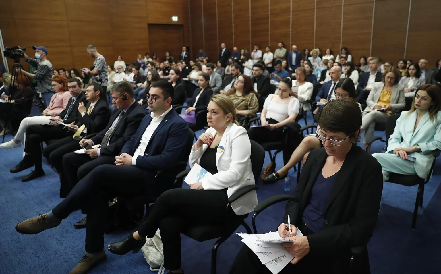 A packed conference hall in Tbilisi shows the kind of venue business travelers use for meetings.