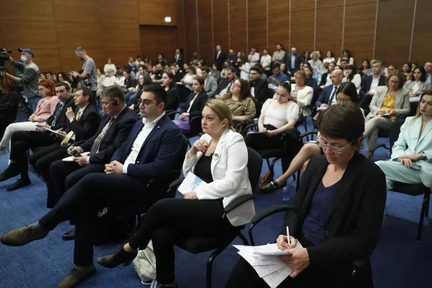 A packed conference hall in Tbilisi shows the kind of venue business travelers use for meetings.