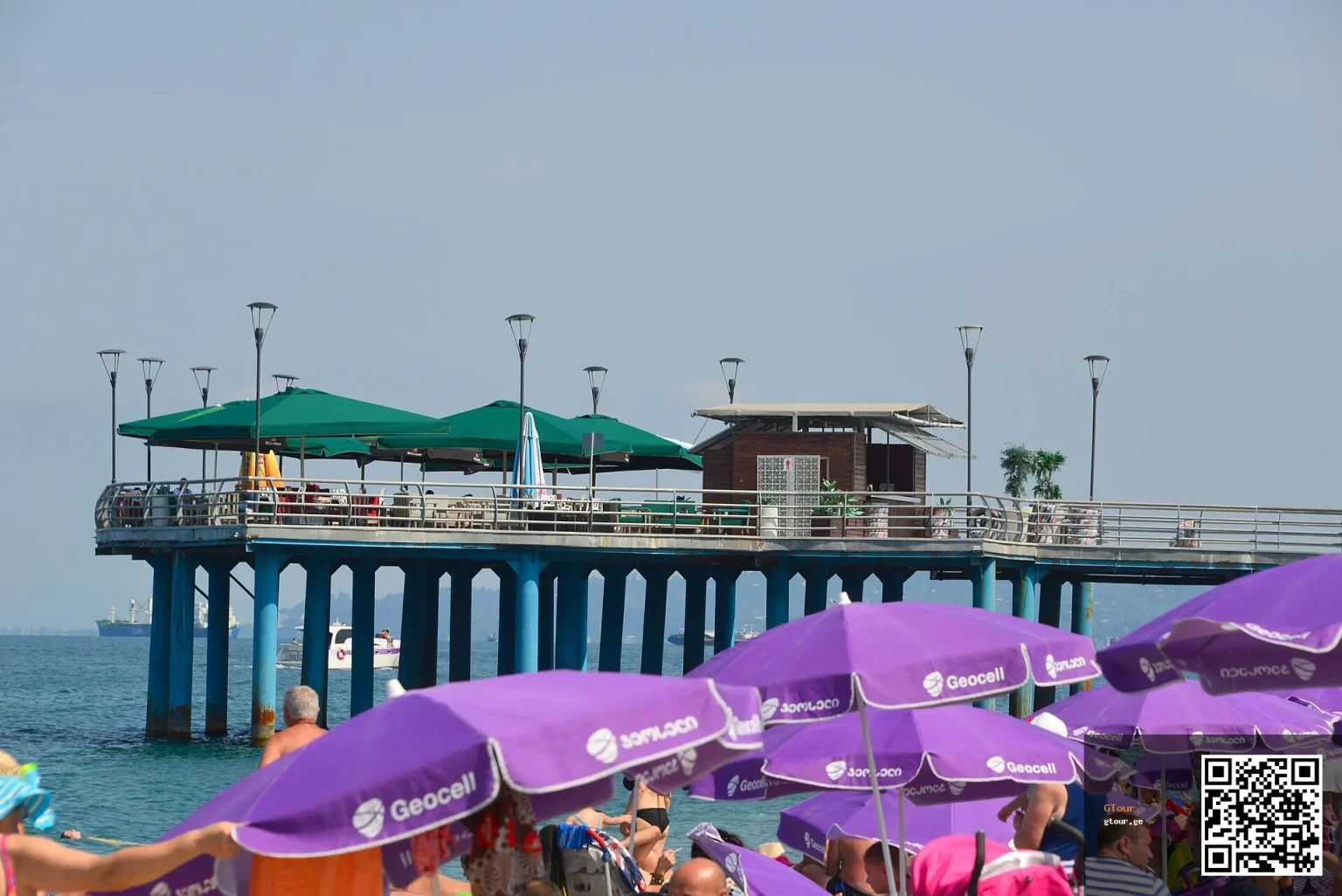 Beach-goers under umbrellas along Batumi's seafront promenade, a common Black Sea entry point.