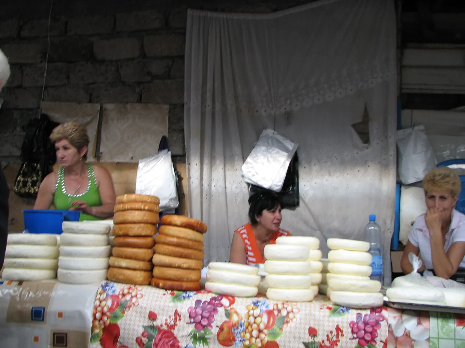Vendors sell stacks of fresh Georgian cheese at the Sukhumi bazaar.