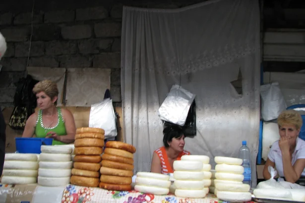 Vendors sell stacks of fresh Georgian cheese at the Sukhumi bazaar.