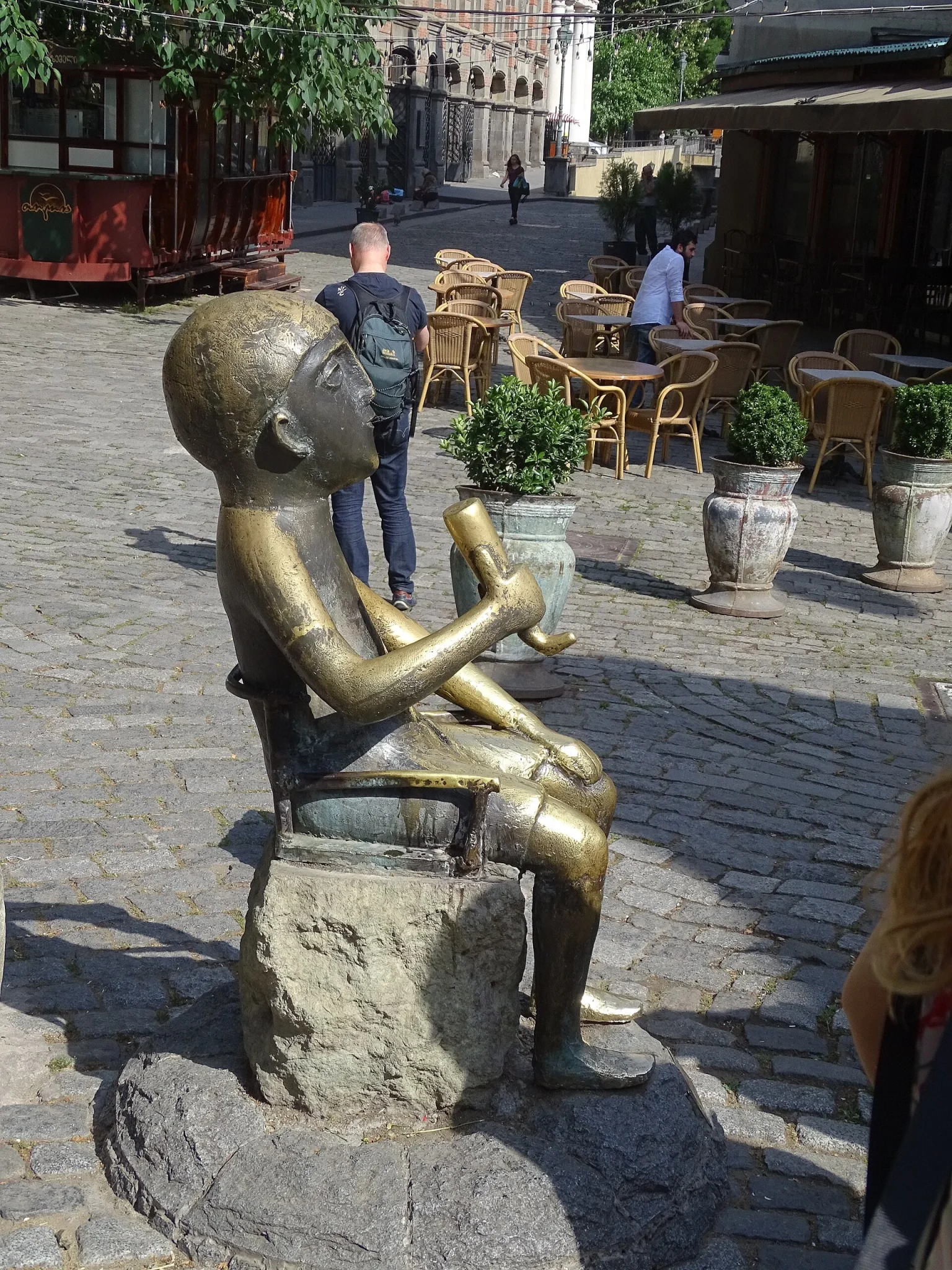 A bronze Tamada (toastmaster) statue in Tbilisi's Old Town reflects Georgia's feast and toasting culture.