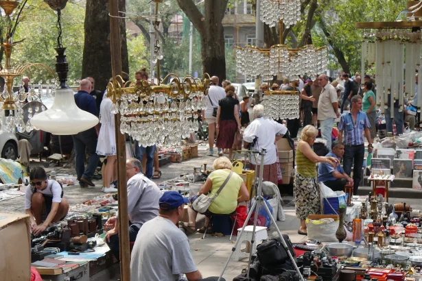 Visitors browse antiques and chandeliers at Tbilisi's famous Dry Bridge Market, a popular stop for travellers.