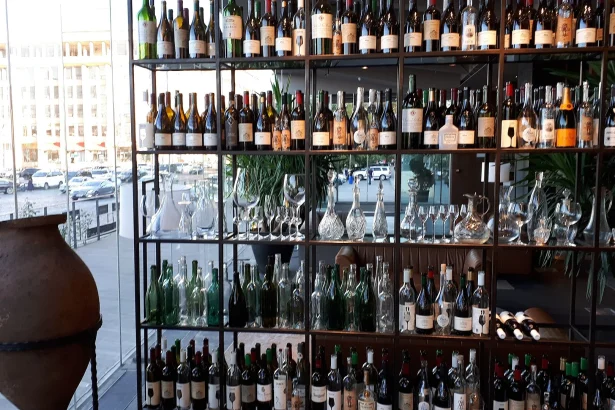 A Tbilisi wine shop displays a traditional clay qvevri jar alongside shelves of Georgian bottles.