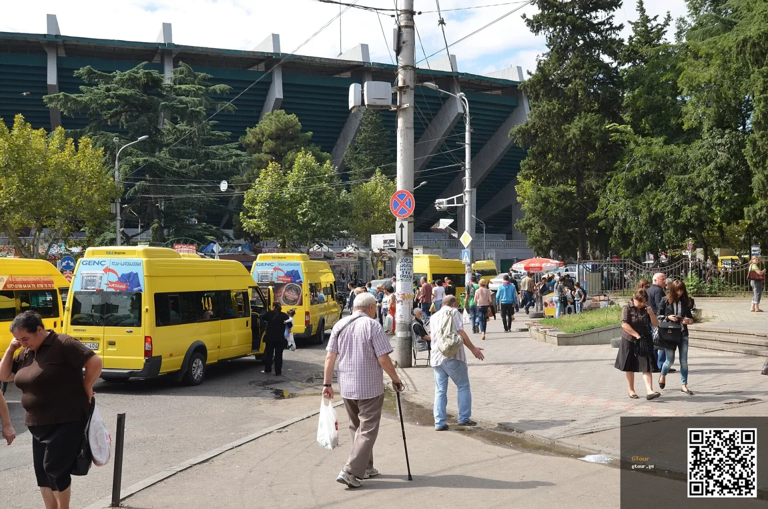 Yellow marshrutka minibuses, a cheap way to get around Tbilisi, wait near Dinamo Arena.