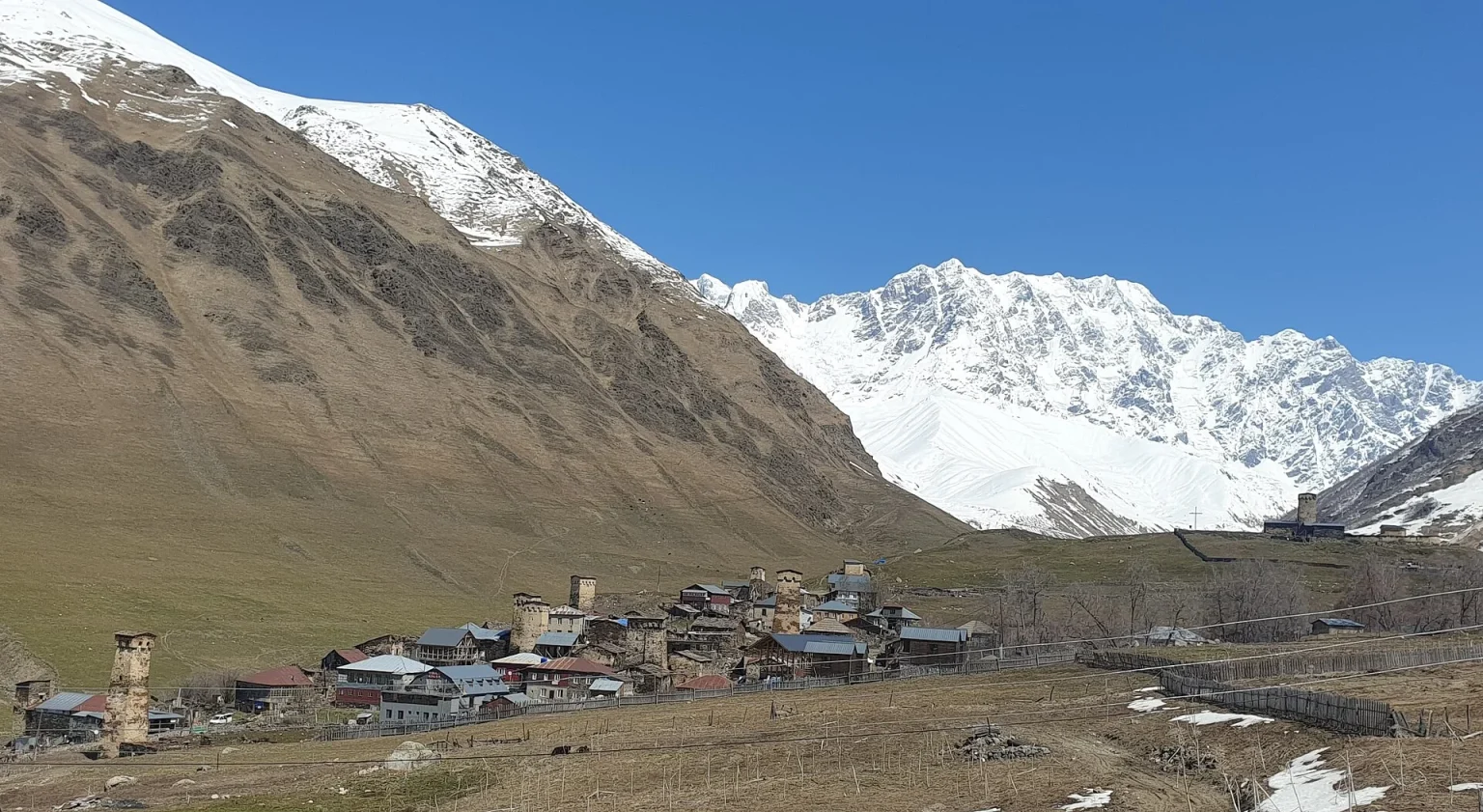 Ushguli village in Svaneti, a peak-season highlight with snow-capped peaks above its medieval tower houses.