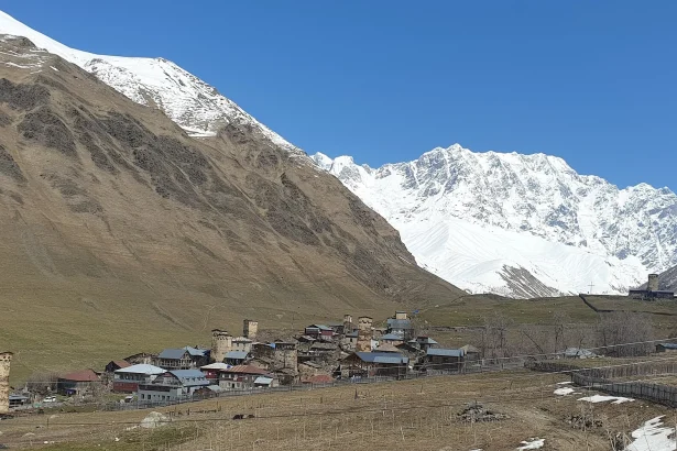 Ushguli village in Svaneti, a peak-season highlight with snow-capped peaks above its medieval tower houses.