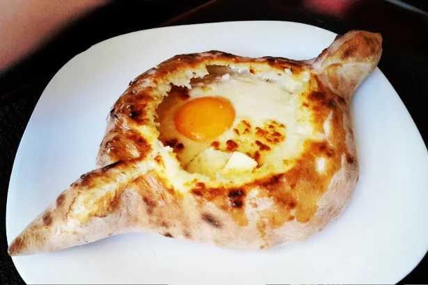 Adjarian khachapuri, a boat-shaped cheese bread with egg, a dish travellers will meet across Georgia.