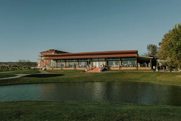 Banquet Hall — Exterior view of the banquet hall building surrounded by green lawns and a pond.