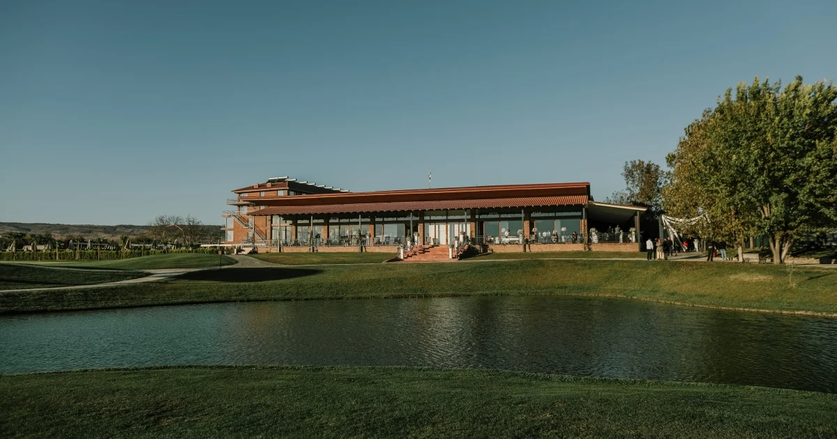 Banquet Hall — Exterior view of the banquet hall building surrounded by green lawns and a pond.