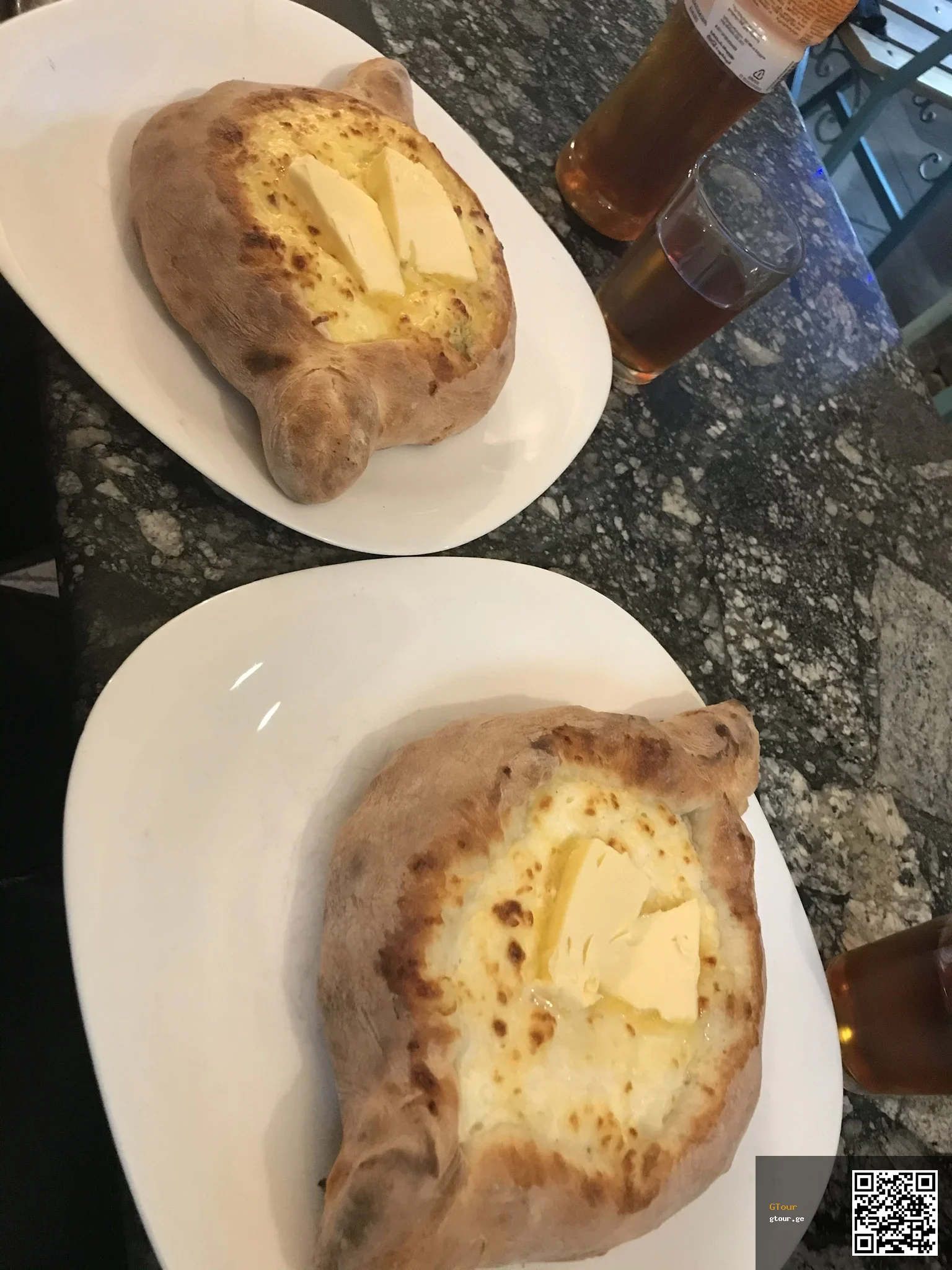 Khachapuri, Georgia's iconic cheese-filled bread, a must-try dish for visitors.